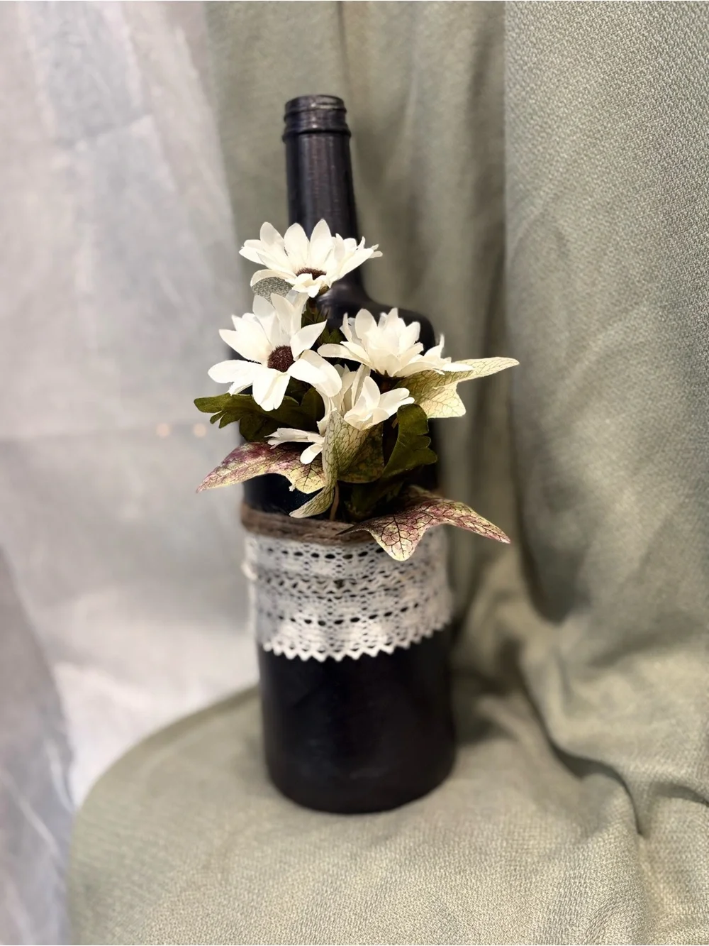 Handcrafted Black Bottle Vase with White Daisies and Lace Accent